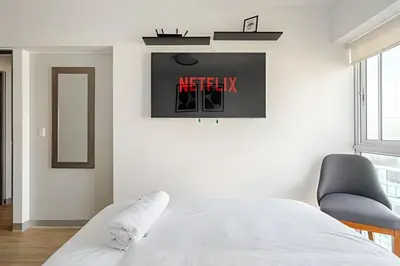a bedroom with a bed and a clock on the wall at Contemporary Great View in Lima
