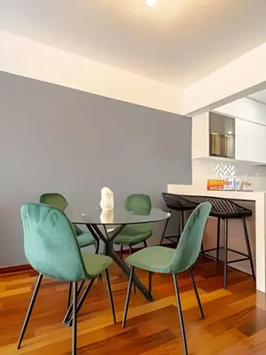a dining room with green chairs and a table at Exclusive Apartment in Miraflores in Lima