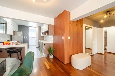 a kitchen and living room with wood paneling at Exclusive Apartment in Miraflores in Lima