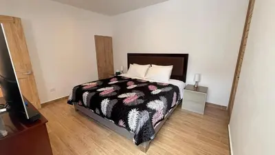 a bedroom with a bed and a television in it at C4s4 RANCH OXAPAMPA in Oxapampa