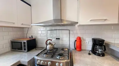 a kitchen with a stove and a microwave at C4s4 RANCH OXAPAMPA in Oxapampa