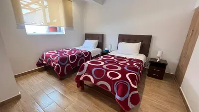 a room with two beds in a room at C4s4 RANCH OXAPAMPA in Oxapampa