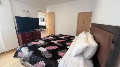 a bedroom with a bed and a television in it at C4s4 RANCH OXAPAMPA in Oxapampa