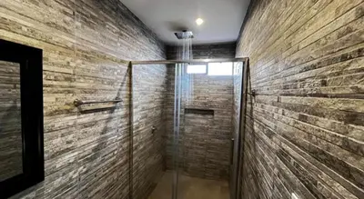 a bathroom with a shower with a glass door at C4s4 RANCH OXAPAMPA in Oxapampa
