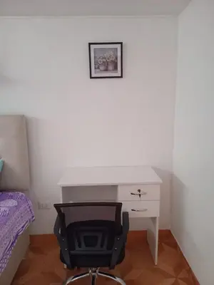 a desk and a chair in a room with a bed at Habitación Estandar con baño privado en Monterrico Sur in Lima