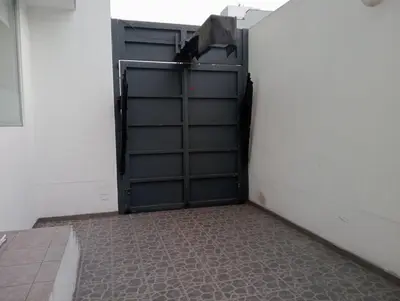 a garage with a garage door open and a tile floor at Apartment in the center of Miraflores in Lima