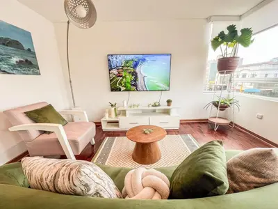 a living room with a couch and a table at LimaViva A in Lima