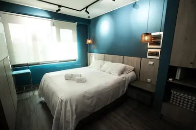 a blue bedroom with a bed with two towels on it at iStay 1bed 1Bathroom Urban Deluxe in Lima