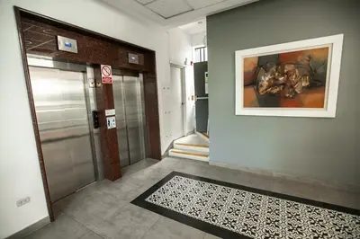 a hallway with a door and a painting on the wall at iStay 1bed 1Bathroom Urban Deluxe in Lima