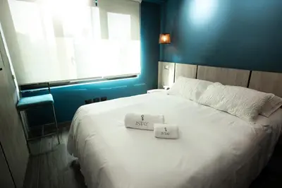 a bedroom with a bed with two towels on it at iStay 1bed 1Bathroom Urban Deluxe in Lima