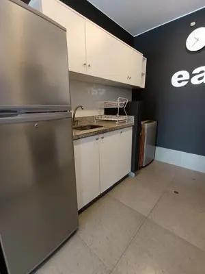 an empty kitchen with a sink and a refrigerator at iStay 2D a 1 cuadra del Malecon in Lima