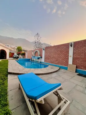 a blue bench sitting next to a swimming pool at Casa Cubo Deluxe in La Molina in Lima