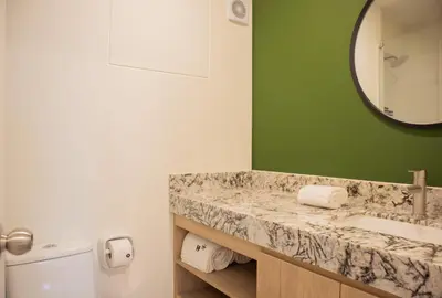 a bathroom with a sink and a mirror at Palma Suites by Wynwood House in Lima
