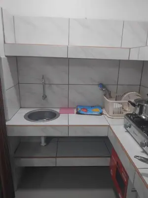 a small kitchen with a sink and a stove at Habitación acogedora in Lima