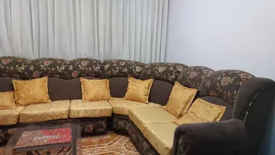 a couch with pillows on it in a living room at H&H home in Cusco