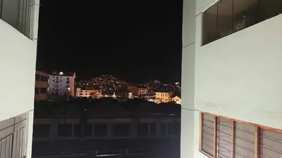 a view of a city at night from a building at H&H home in Cusco