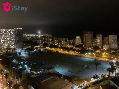 a city skyline at night with a large parking lot at iStay Encantador Loft Piscina BBQ Gym Bicicleta in Lima
