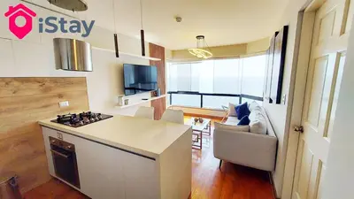 a kitchen and living room with a stove top oven at iStay Espectacular Vista Mar Miraflores in Lima