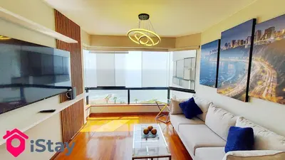 a living room with a couch and a large window at iStay Espectacular Vista Mar Miraflores in Lima