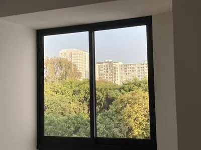 a window with a view of a city at iStay Santuario Linsidro Cerca Hospitales Gym in Lima