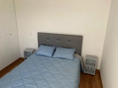 a bedroom with a bed with two blue pillows at iStay Santuario Linsidro Cerca Hospitales Gym in Lima