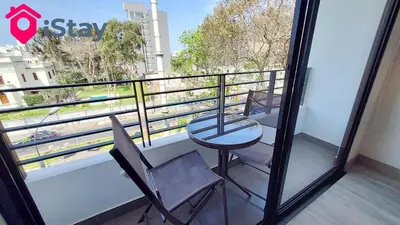 a balcony with a table and a chair and a view at iStay Nuevo 2D 2B Balcón in Lima