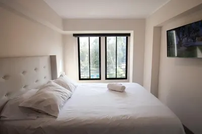 a bedroom with a white bed with a window at iStay Nuevo 2D 2B Balcón in Lima