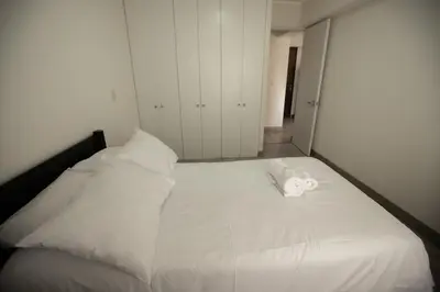 a white bed with a towel on top of it at iStay Nuevo 2D 2B Balcón in Lima