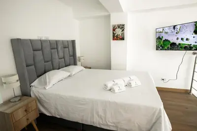 a bedroom with a large bed with towels on it at Mezanine Deluxe Miraflores in Lima