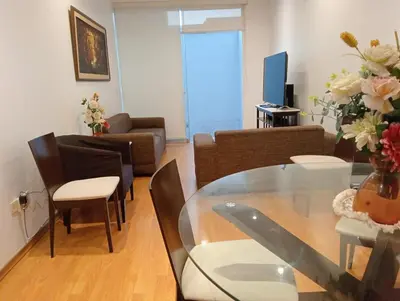 a living room with a glass table and a couch at Super departamento en el centro de Miraflores in Lima