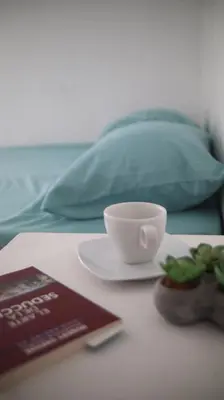 a table with a plate and a cup and a book at PARACAS Sotavento T2 401 in Paracas