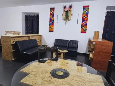 a living room with a table and chairs at Chakanas House in Cusco