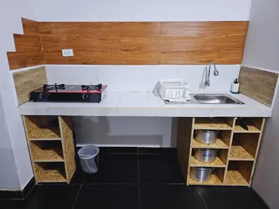 a small kitchen with a sink and a stove at Chakanas House in Cusco