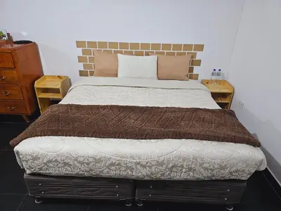 a bedroom with a large bed with two night stands at Chakanas House in Cusco