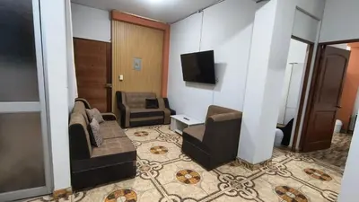 a living room with a couch and a chair at Departamentos Sumaq Plaza - Libertad in Ayacucho