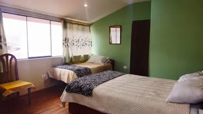a small room with two beds and a window at Cozy Mini-Apartment-Cusco in Cusco