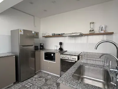 a kitchen with a sink and a stainless steel refrigerator at 2Br Apartment Miraflores in Lima