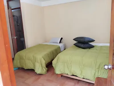 a bedroom with two beds and a pillow on the bed at Glamping Machupicchu Lodge in Santa Teresa