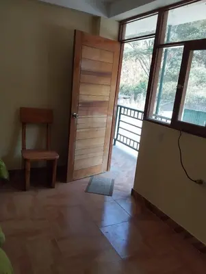 a room with a door and a chair and a window at Glamping Machupicchu Lodge in Santa Teresa