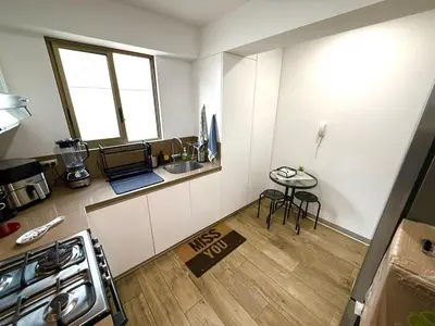 a small kitchen with a sink and a table at Inka Home VIP Luxury total 2 Private parking spaces in Lima