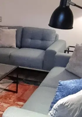 a living room with a blue couch and a lamp at Inka Home VIP Luxury total 2 Private parking spaces in Lima