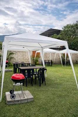 a white tent with tables and chairs under it at La Posada de Chango in La Merced