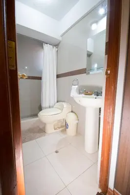 a bathroom with a toilet and a sink at Elite Apartment in Cusco