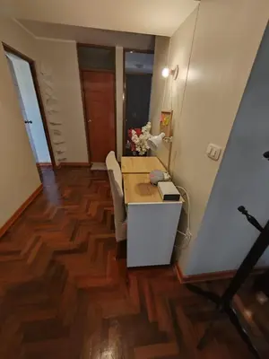 a room with a desk and a table with chairs at Elite Apartment in Cusco