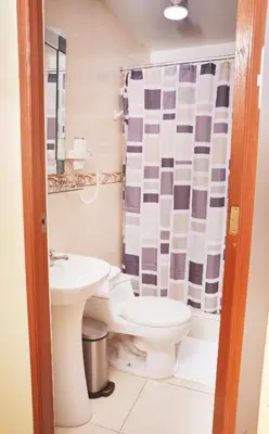 a bathroom with a toilet and a sink at Hostel Esperanza in Lima