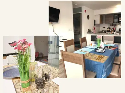 a kitchen and a dining room with a table with flowers on it at Milyshomeperu in Lima
