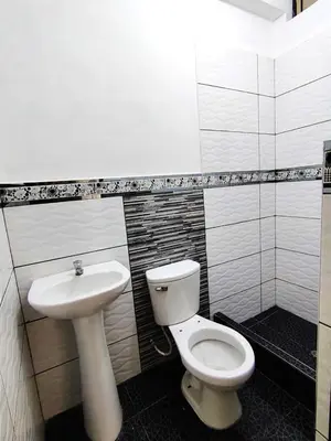 a bathroom with a toilet and a sink at Casa de campo familiar cn parrilla, WiFi y piscina