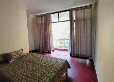 a bedroom with a bed and a large window at Casa de campo familiar cn parrilla, WiFi y piscina