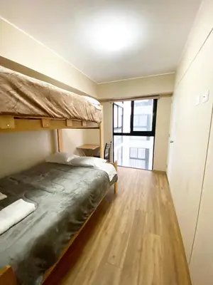 a bedroom with two bunk beds and a wooden floor at Exclusive apartment in Miraflores in Lima