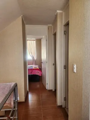 a hallway with a room with a bed and a window at Apartamento duplex en ICA in Pueblo Nuevo